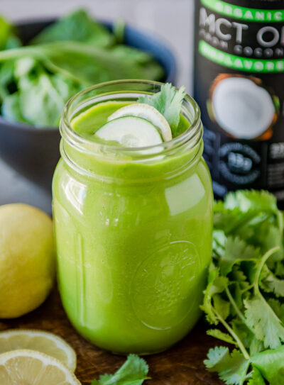 Healthy fat smoothie next to fresh ingredients and a bottle of MCT oil