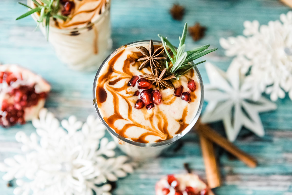 Glass of gingerbread smoothie recipe with holiday toppings.