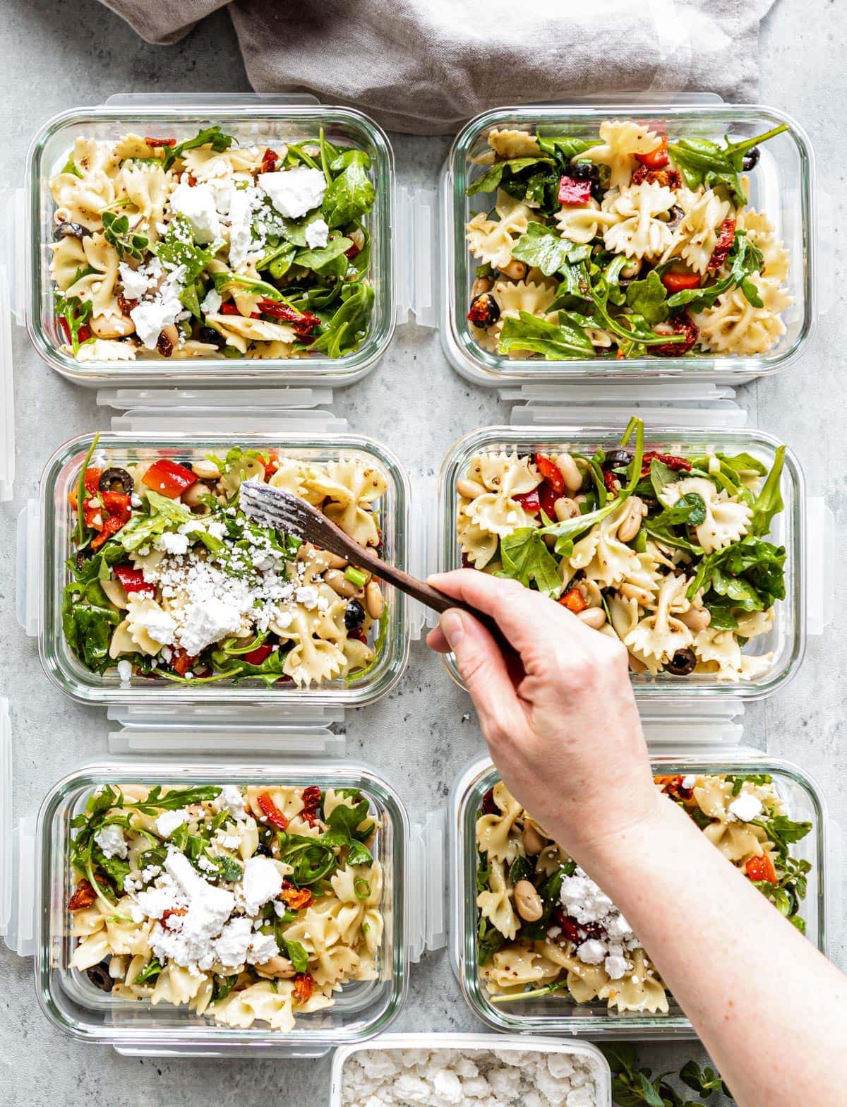 6 glass containers of pasta salad.