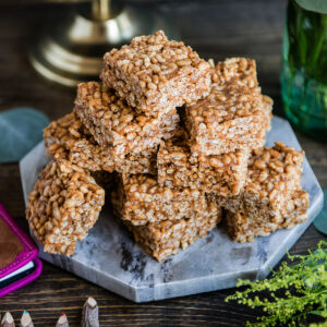Marble plate with healthy rice crispy treats stacked on top.