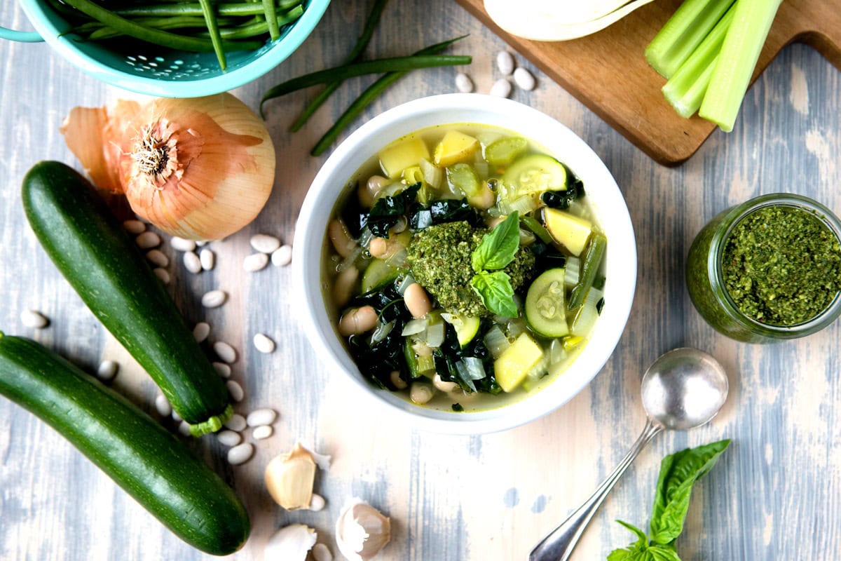 Fresh zucchini and herbs in a bowl of healthy soup with vegetables and greens.
