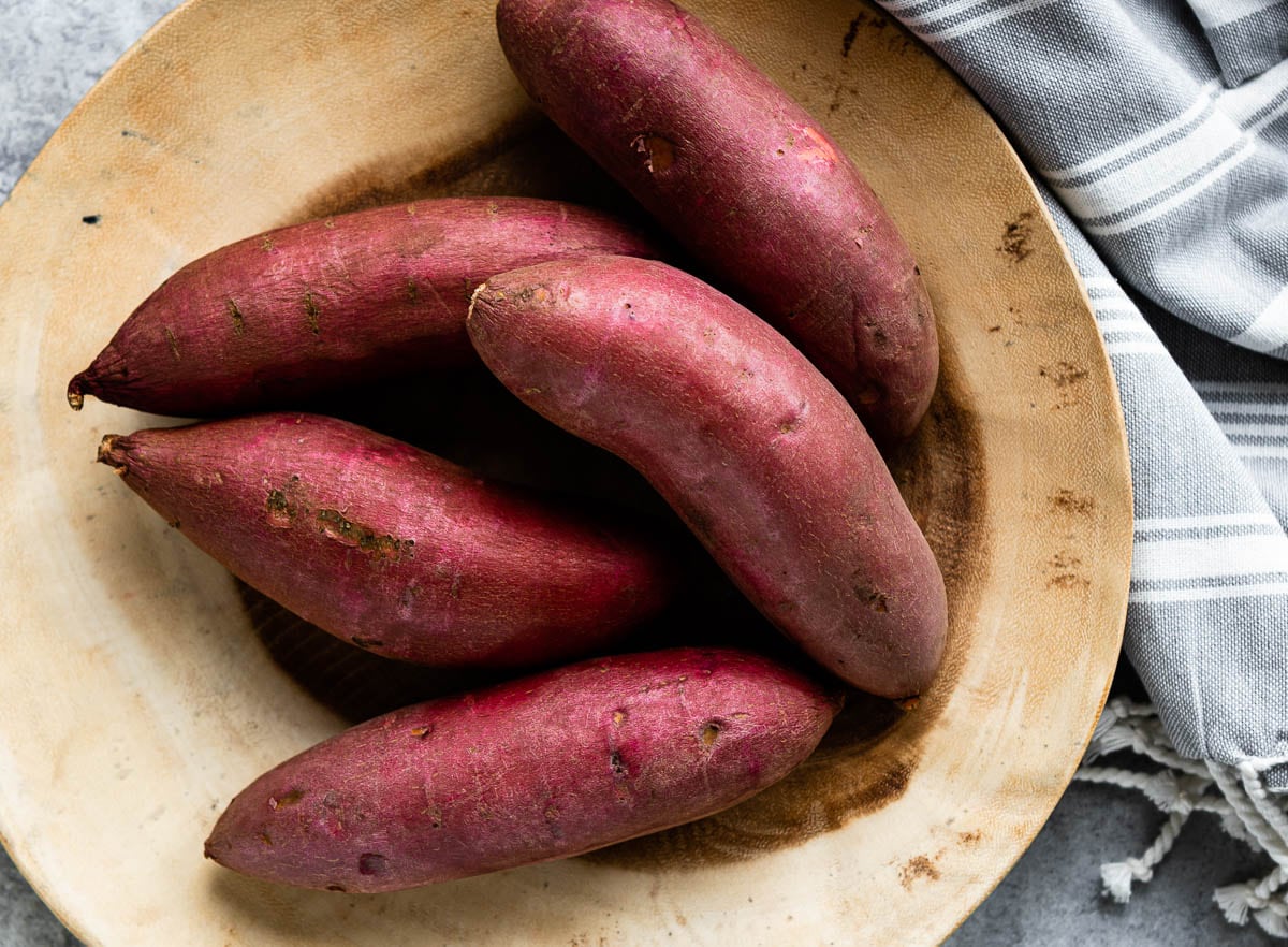 bowl of raw sweet potatoes ready to be used in quick and easy sweet potato recipes.