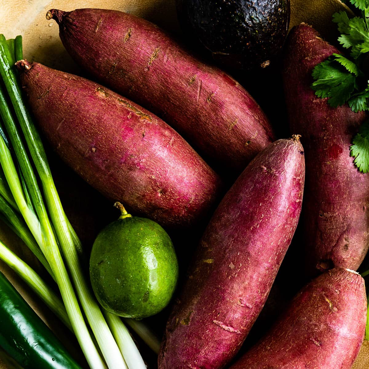 photo of sweet potatoes, green onions, limes and cilantro used in healthy sweet potato recipes
