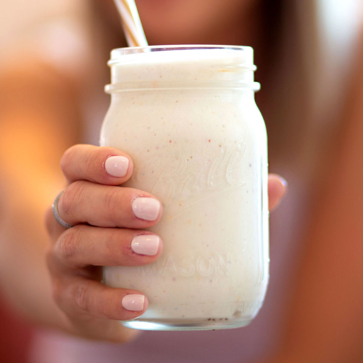 Glass with healthy vanilla protein shake recipe in it.