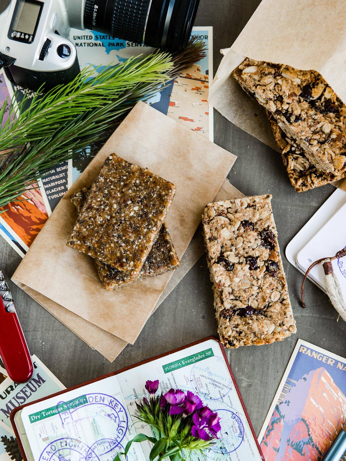 2 different types of homemade granola bars for healthy workout snacks, on parchment paper.