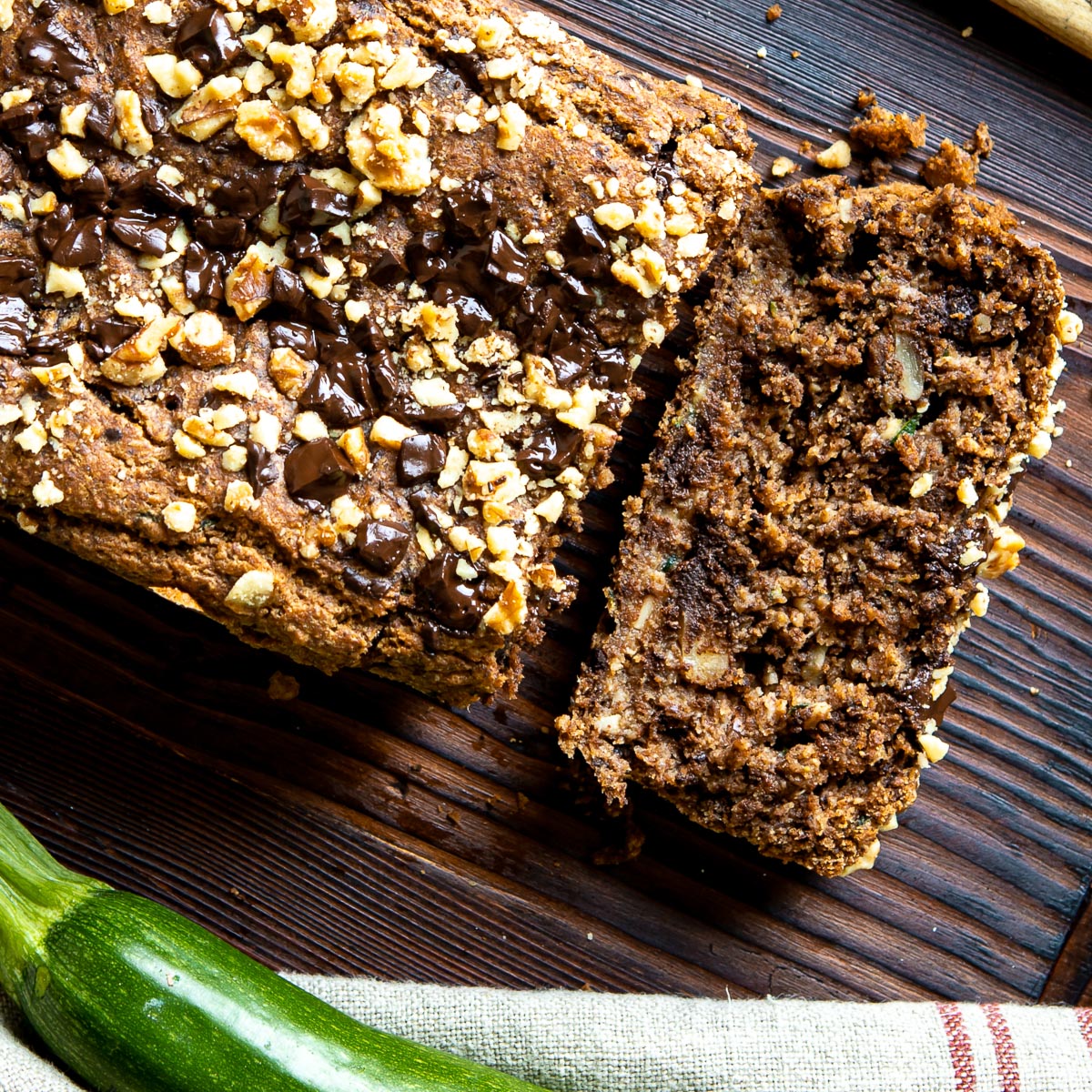 Partially-sliced loaf of zucchini bread.