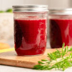 Two mason jars of homemade V8 juice on the counter