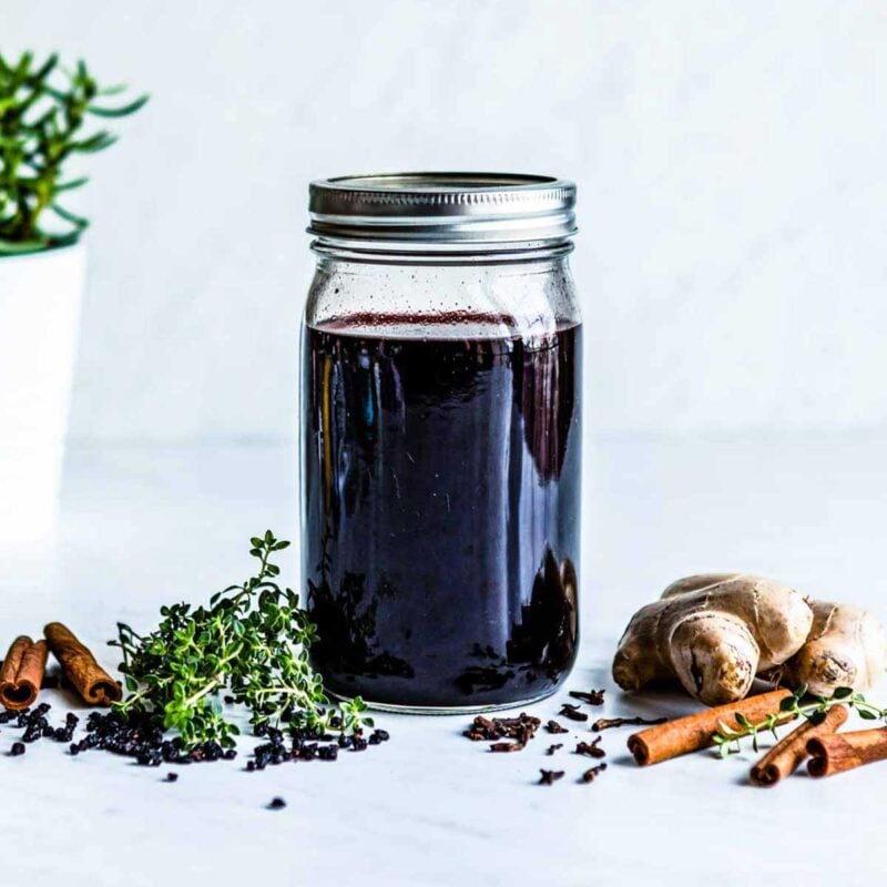 Elderberry syrup in a glass jar.