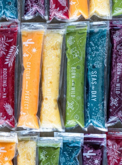 Homemade ice pops recipes on counter in variety of colors.