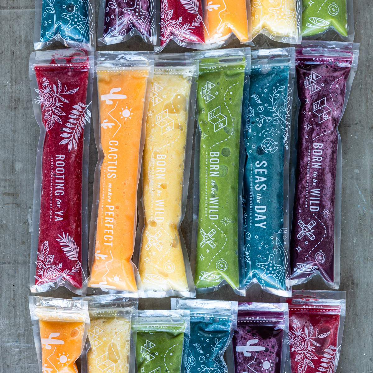 Homemade ice pops recipes on counter in variety of colors.