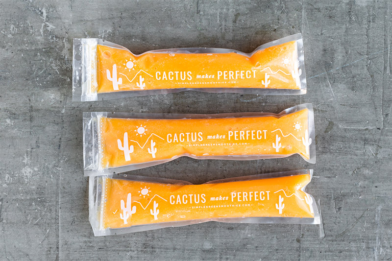 Yellow homemade ice pops recipe in three plastic freezer sleeves.
