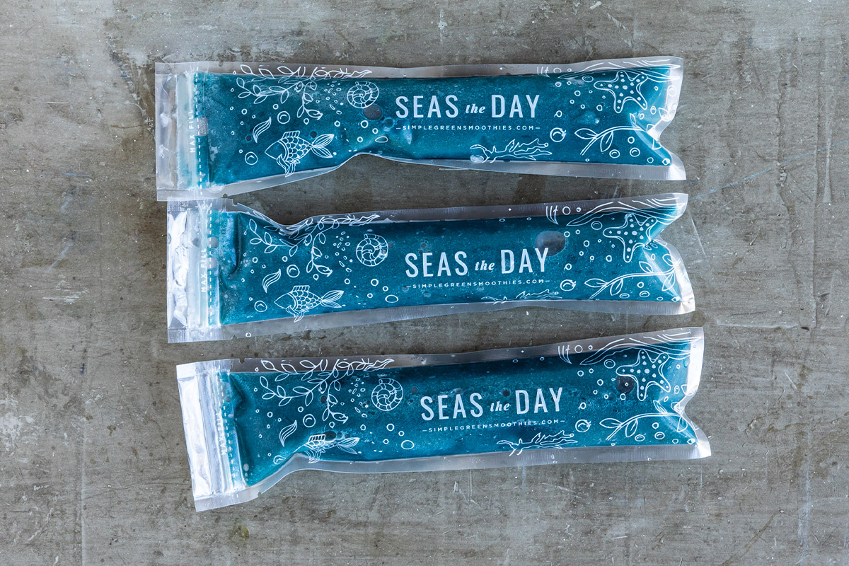Blue homemade ice pops in plastic sleeves.