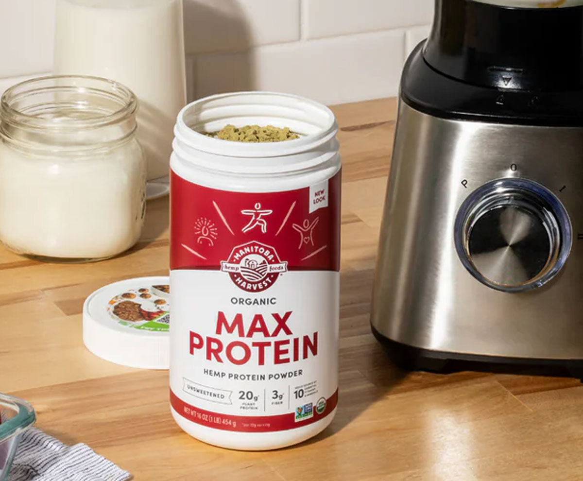 Container of max hemp protein powder with smoothie.