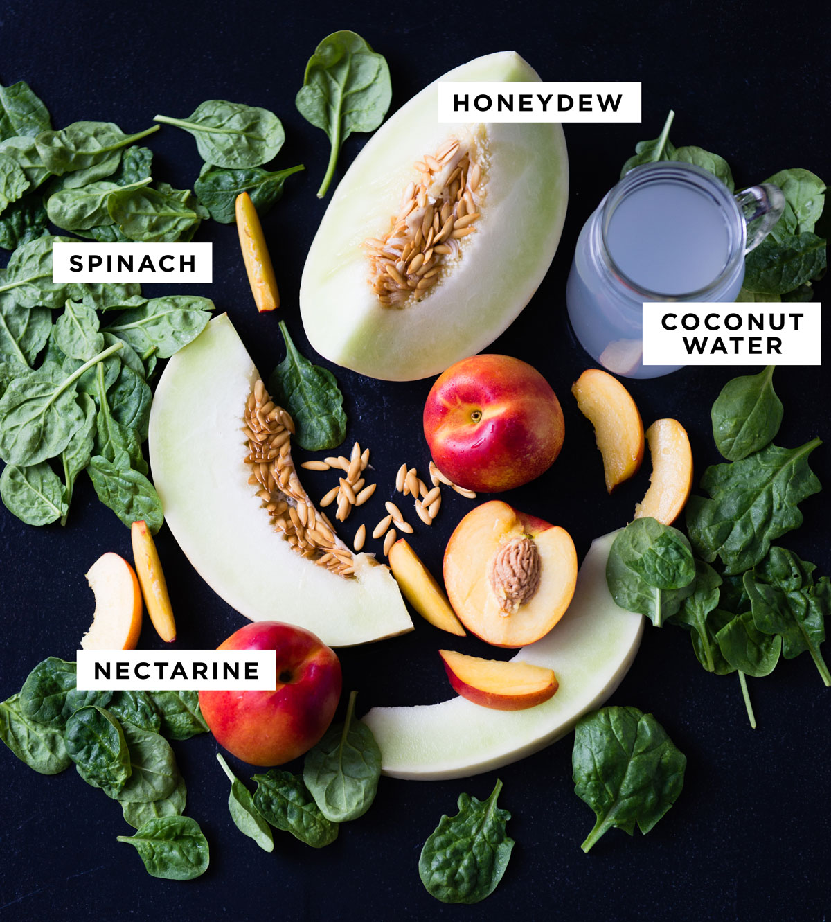 labeled ingredients for a honeydew smoothie including honeydew, spinach, coconut water and nectarine.