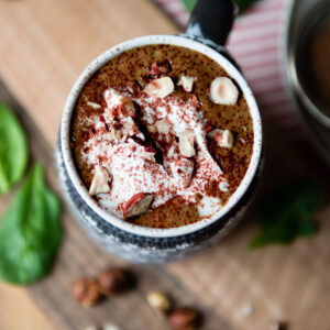 Mug of hot chocolate smoothie on table