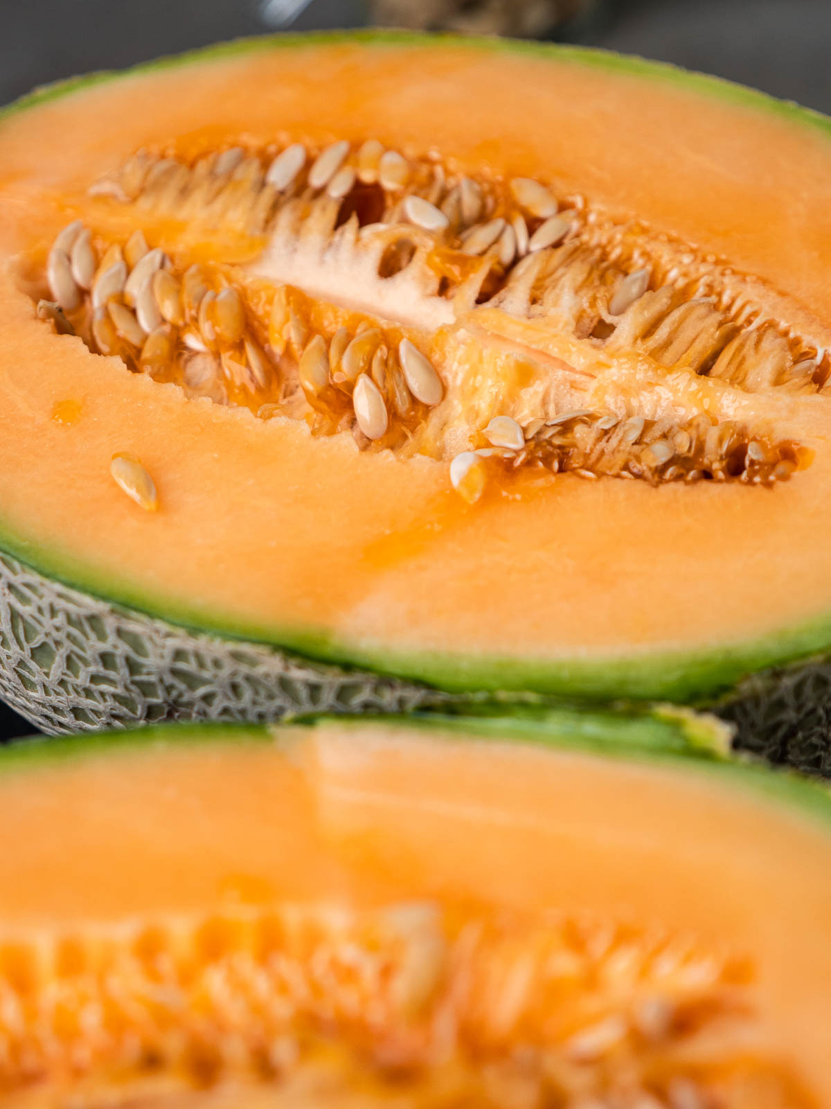 inside of a halved cantaloupe with the seeds still inside.