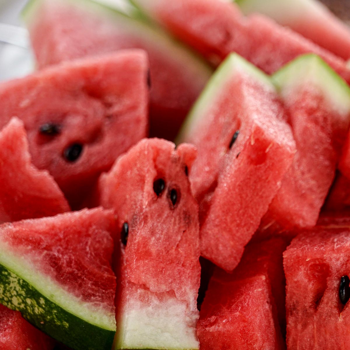several slices of cut watermelon with the rind on.