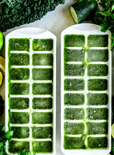 Ice cube tray with frozen spinach cubes.