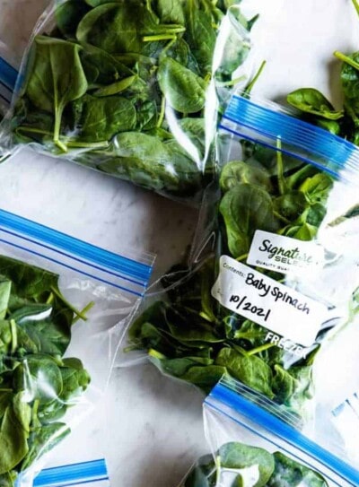 making bags of spinach to show how to freeze spinach.