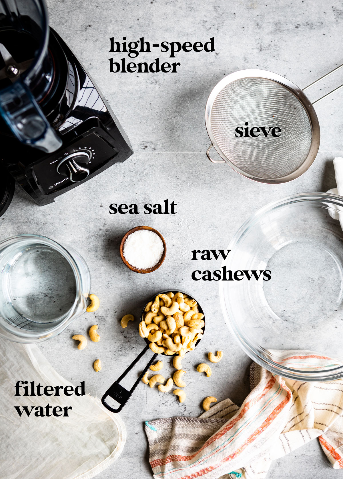 Ingredients to make cashew milk on table with blender.