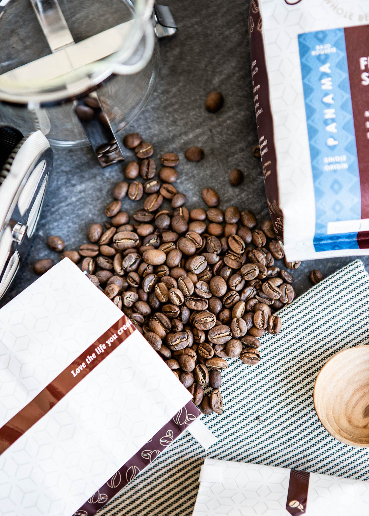 whole beans poured out of a bag onto a counter.