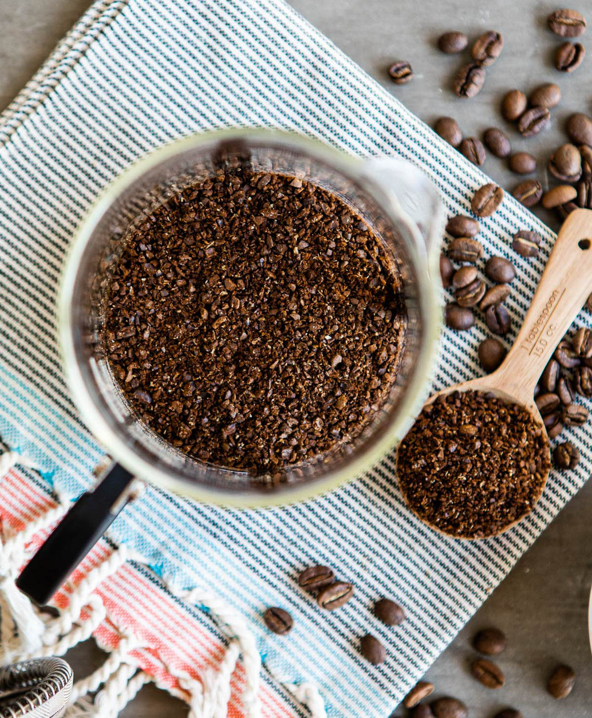 ground coffee in a tablespoon scoop and poured into a french press container.
