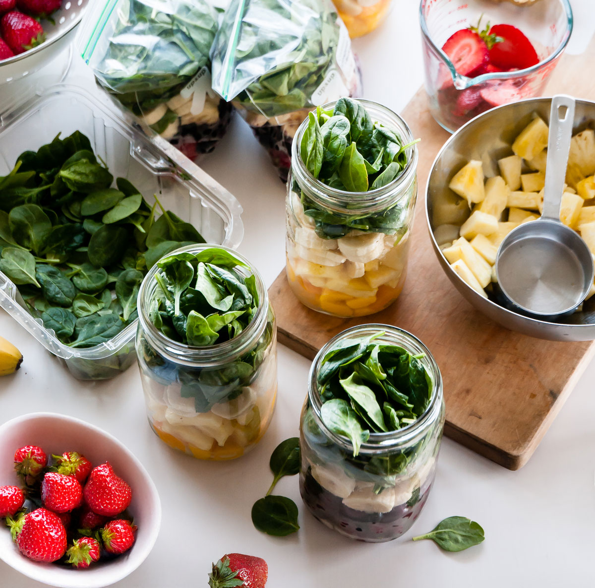 measuring fruit to make smoothies ahead and store in mason jars