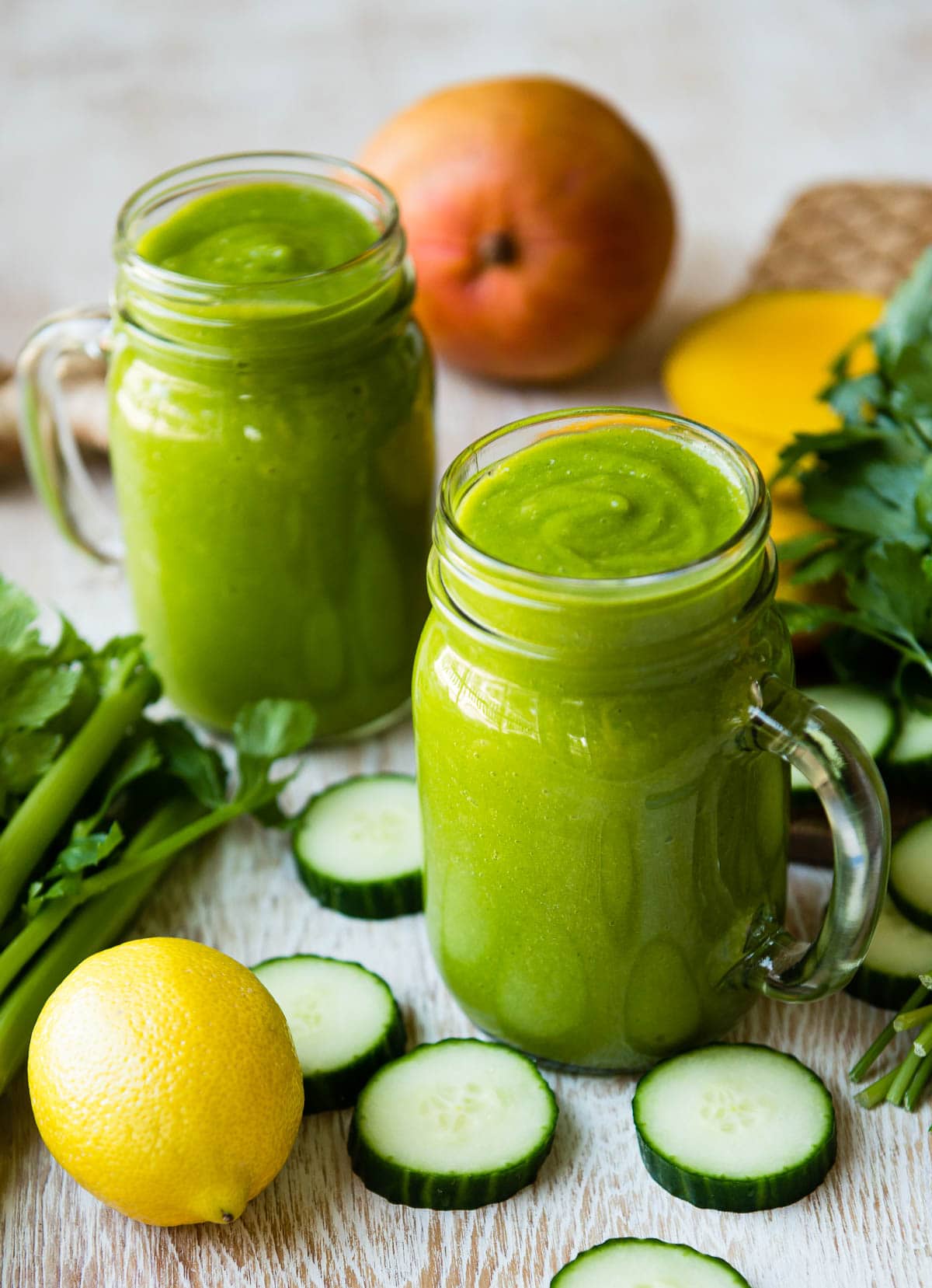 photo of 2 green smoothies in glass jars full of ingredients to boost your immune system quickly