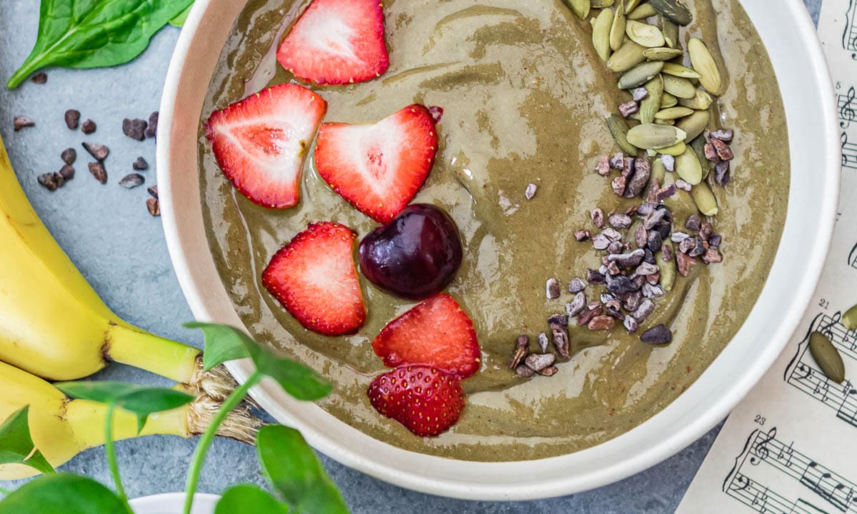 iron-rich smoothie bowl topped with fruit, cacao nibs and pepitas.