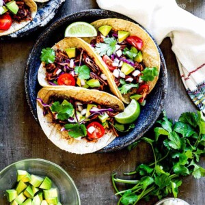 Three barbeque jackfruit tacos on a plate.
