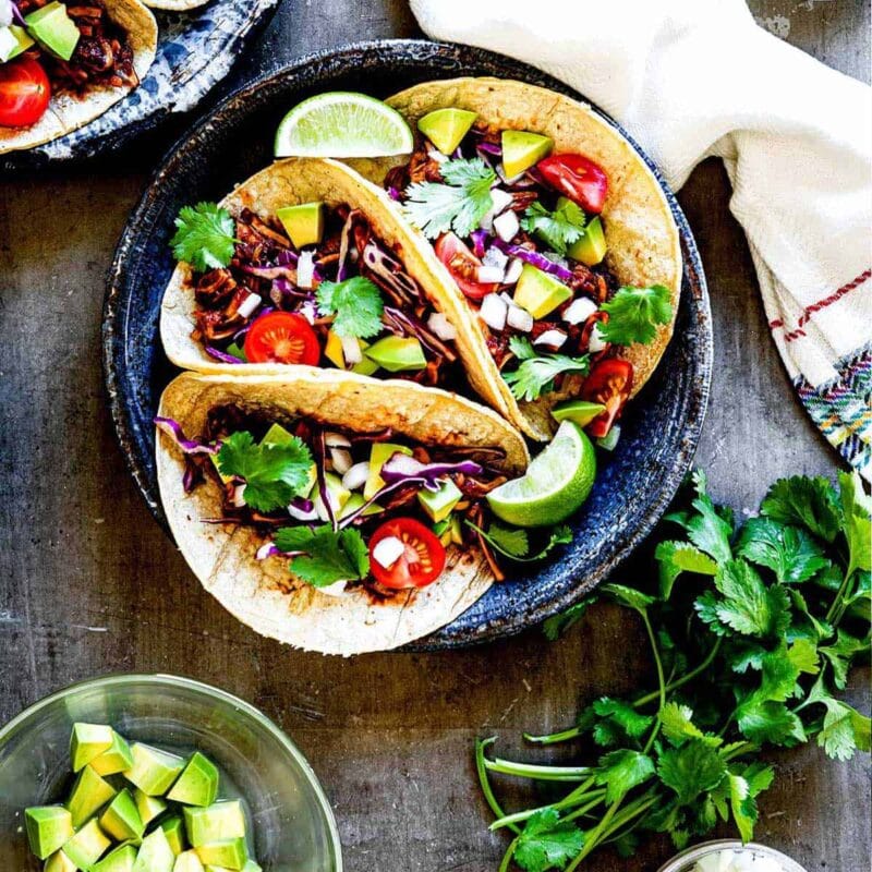 Three barbeque jackfruit tacos on a plate.