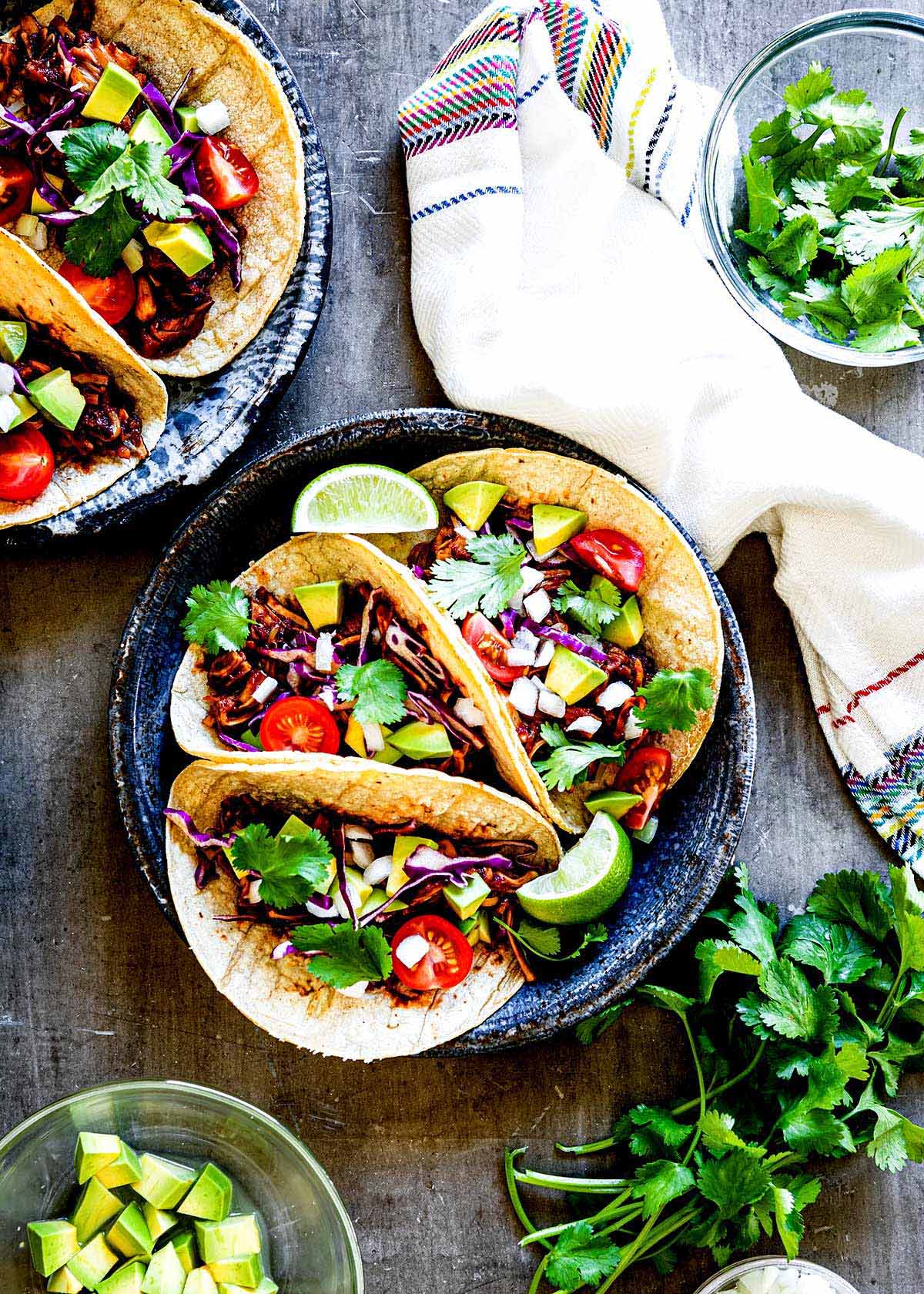 Three barbeque jackfruit tacos on a plate.