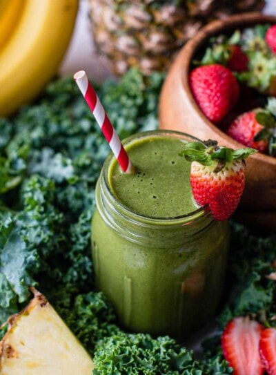 kale banana smoothie surrounded by fresh ingredients.