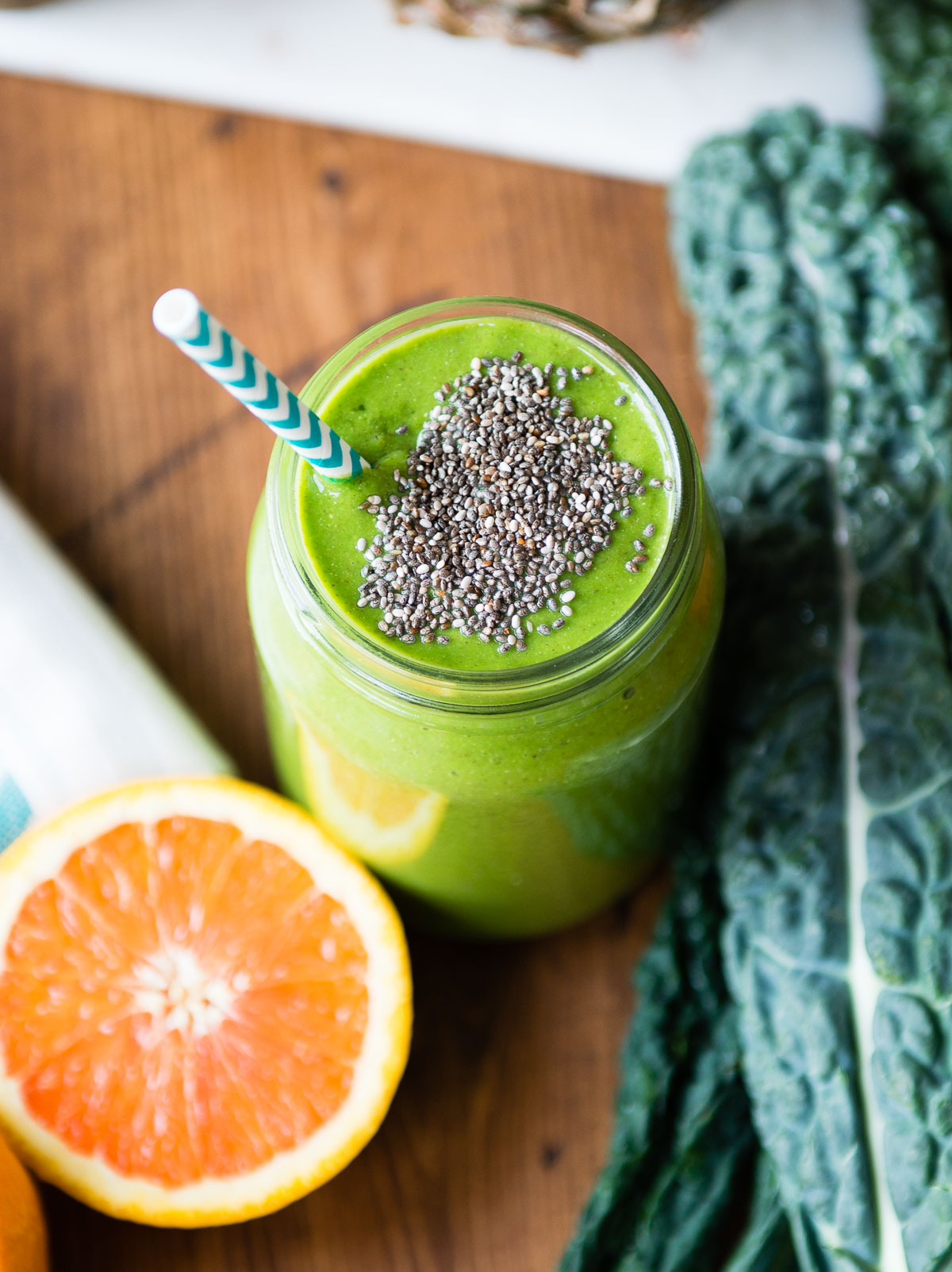 Vibrant kale smoothie in a glass jar and garnished with chia seeds