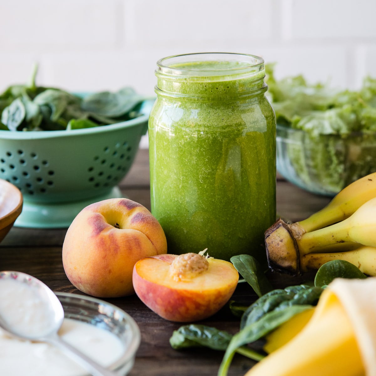A glass of kefir smoothie surrounded by ingredients