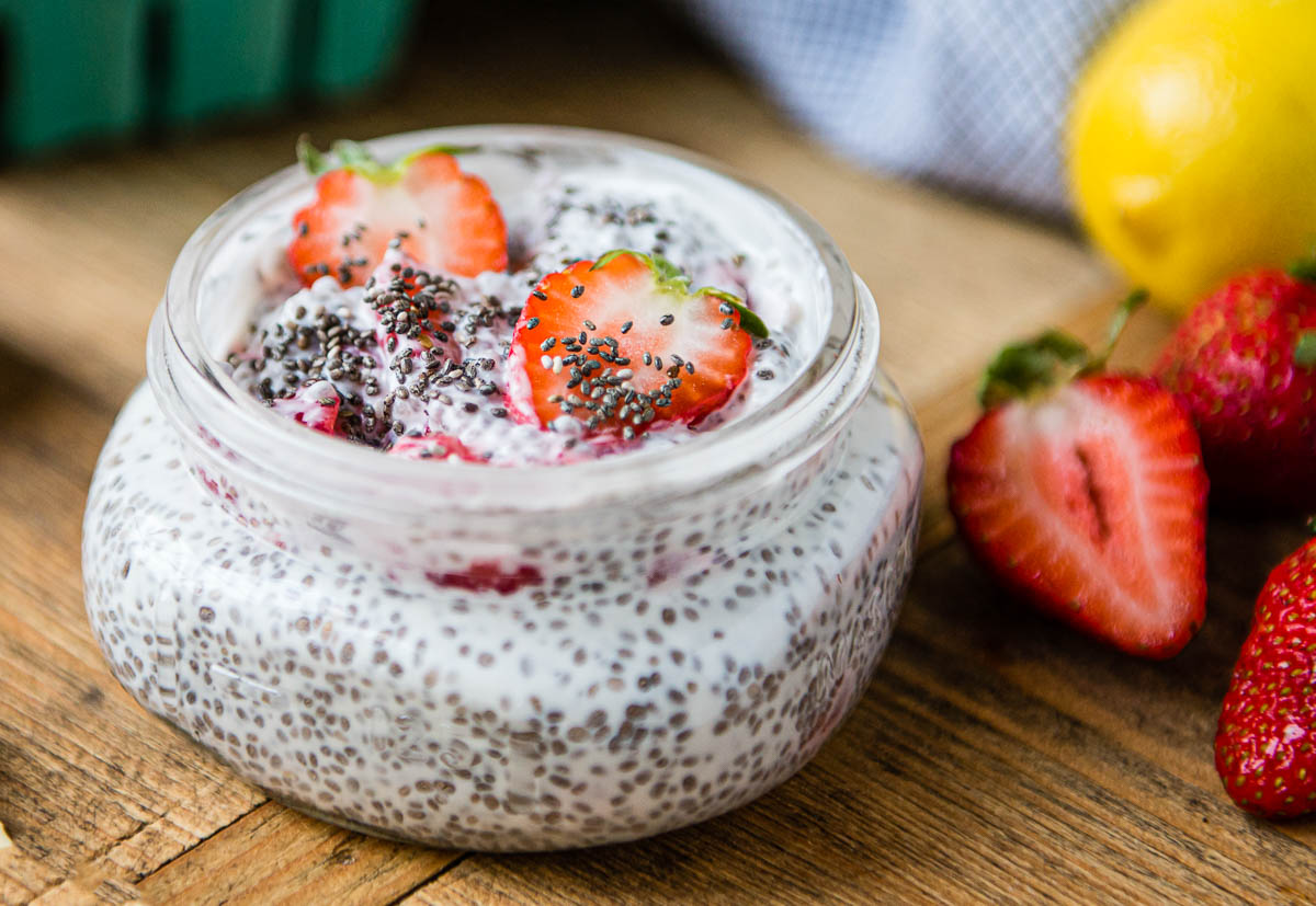 chia pudding in a glass jar with sliced strawberries.