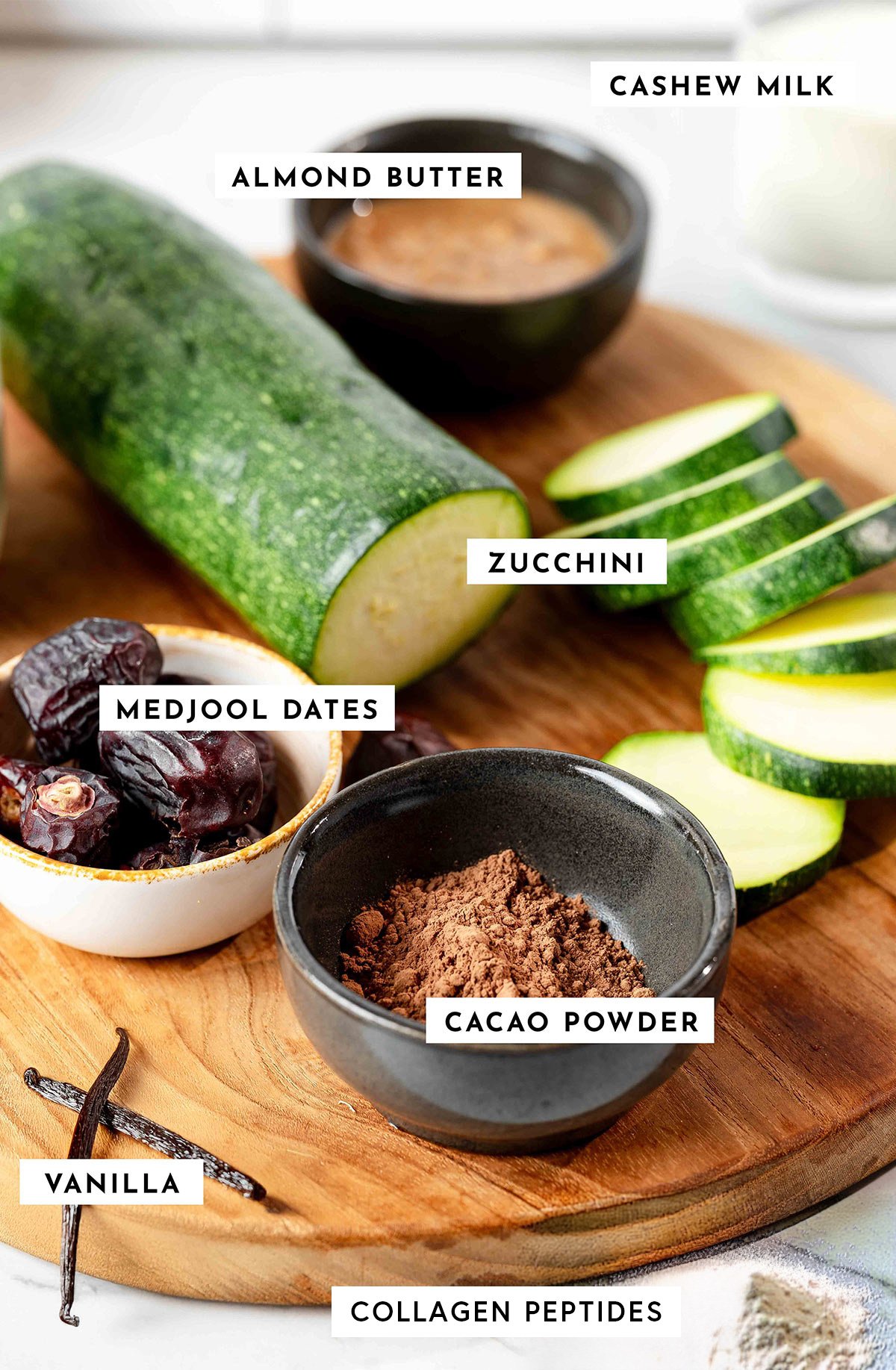 Ingredients to make zucchini smoothie in bowls on countertop