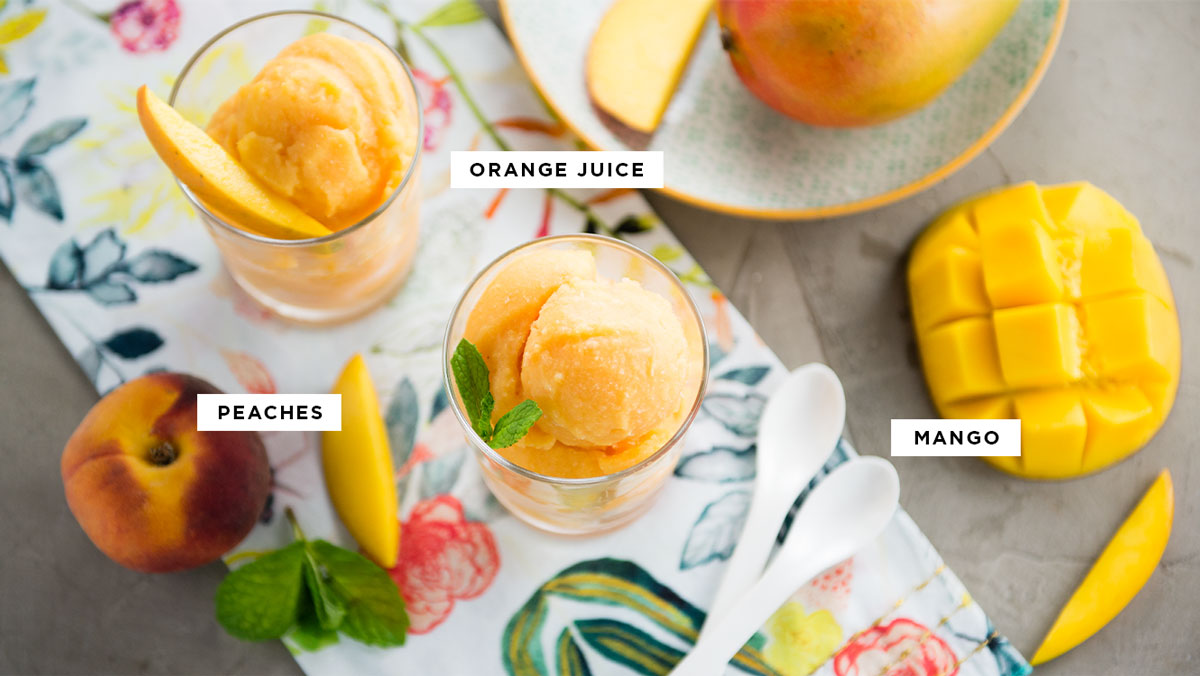 labeled ingredients for fresh dessert including orange juice, peaches and mango.