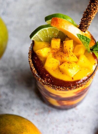 glasses of mangonada recipe with a chamoy sauce and tamarind straw.