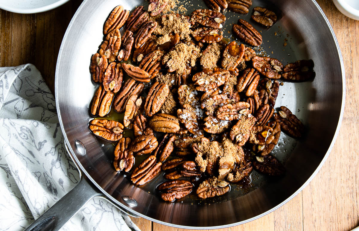 Ingredients for making candy pecans in a metal skillet
