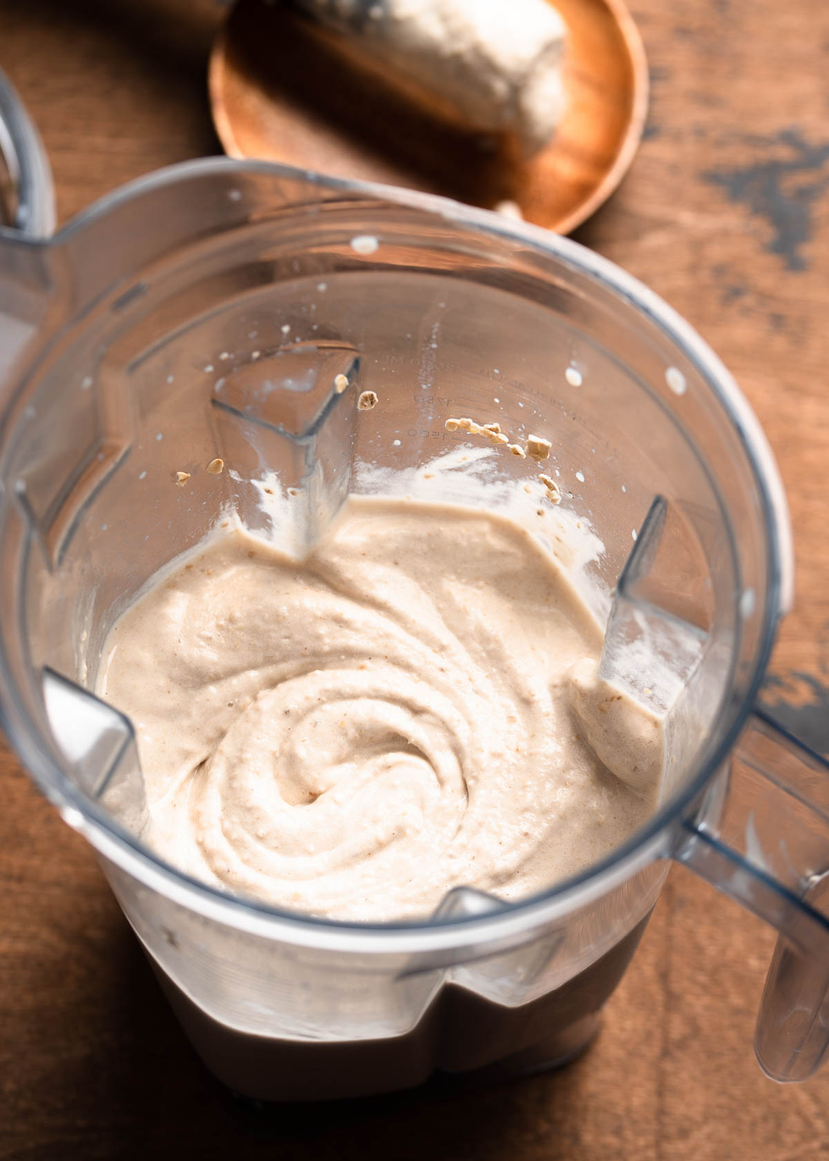 blender container with creamy smoothie bowl.