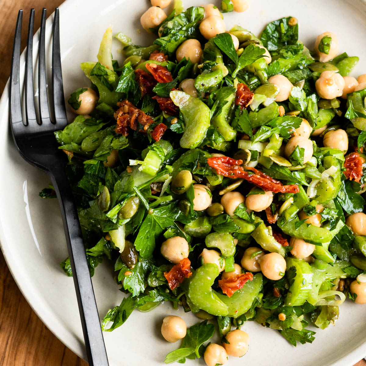 Fork on a plate of marinated celery salad.