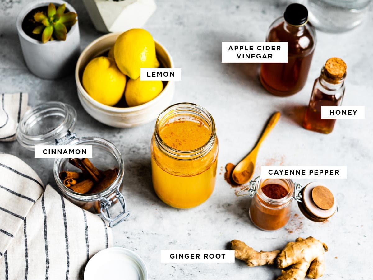 labeled ingredients for foods that boost your metabolism including apple cider vinegar, honey, cayenne pepper, ginger root, lemon and cinnamon.