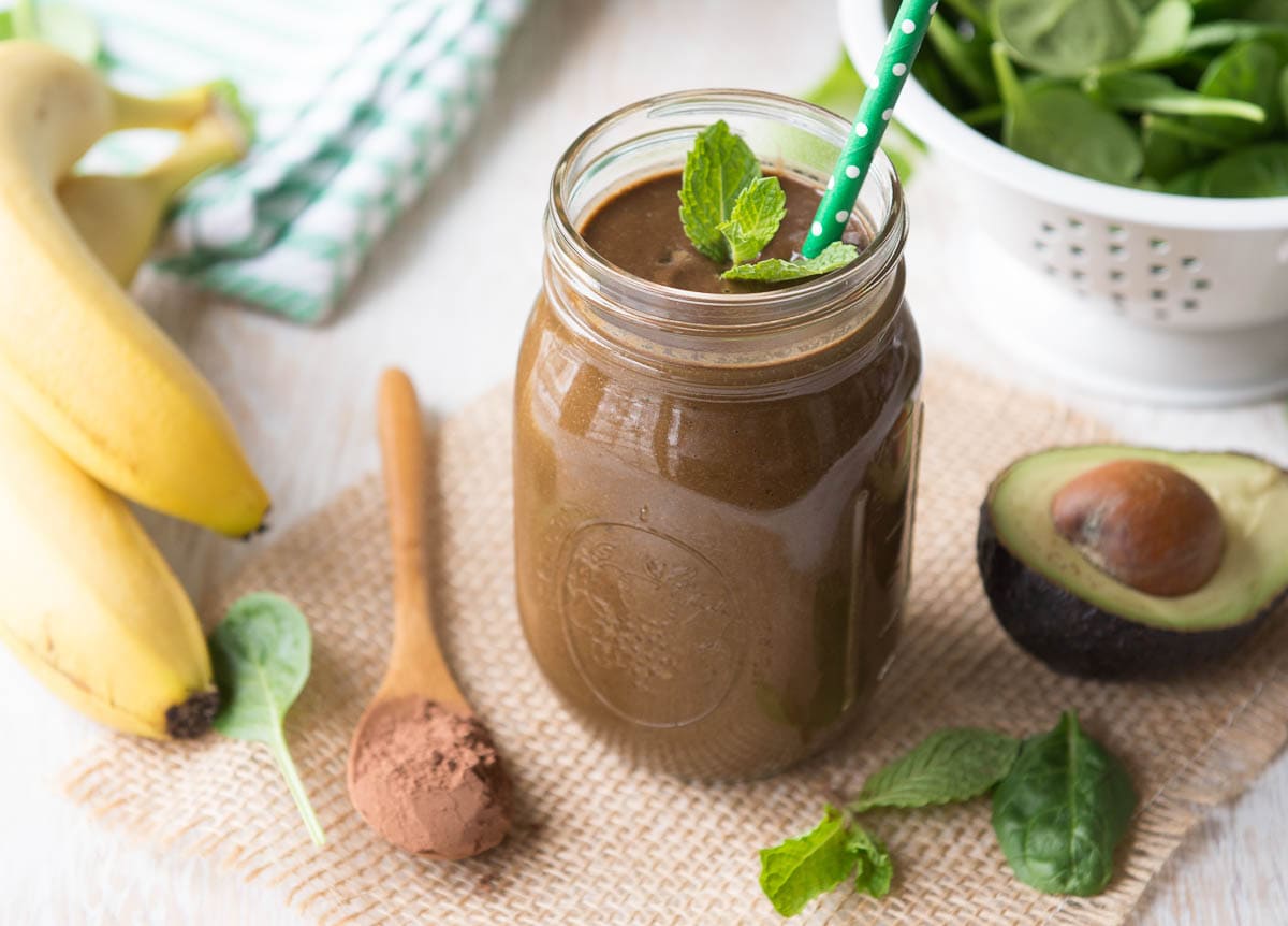 photo of a chocolate protein shake surrounded by fresh, whole ingredients
