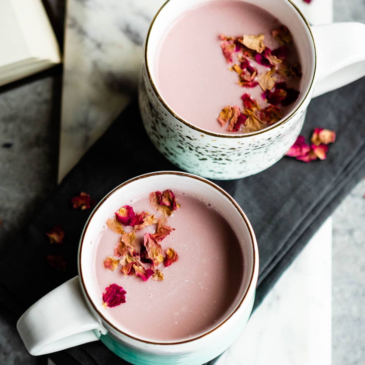 pink moon milk with culinary rose petals in 2 white mugs