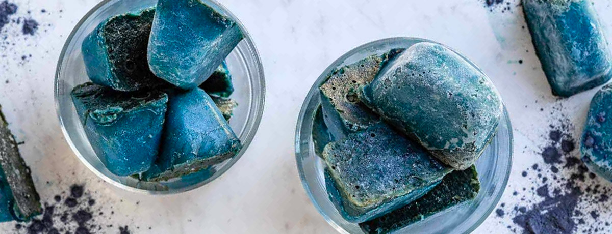 blue ice cubes in two different glasses