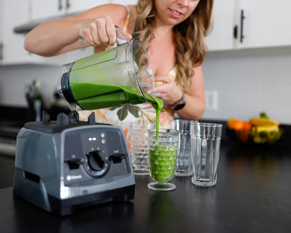 pouring no banana smoothies into glasses for serving from a vitamix.