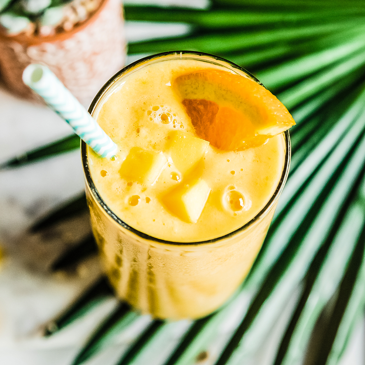 No banana smoothie in glass with straw