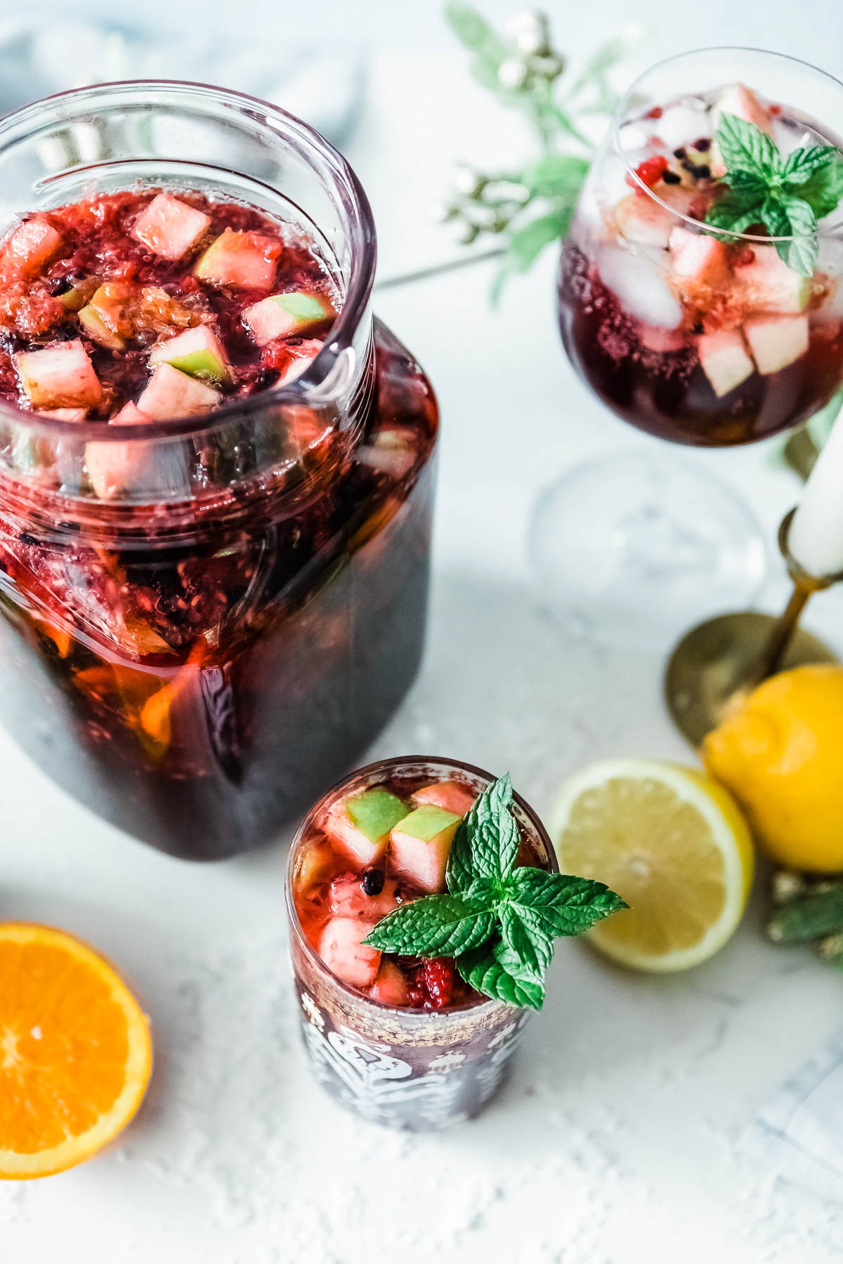 Non-alcoholic sangria drink in a pitcher and a matching drinking glass