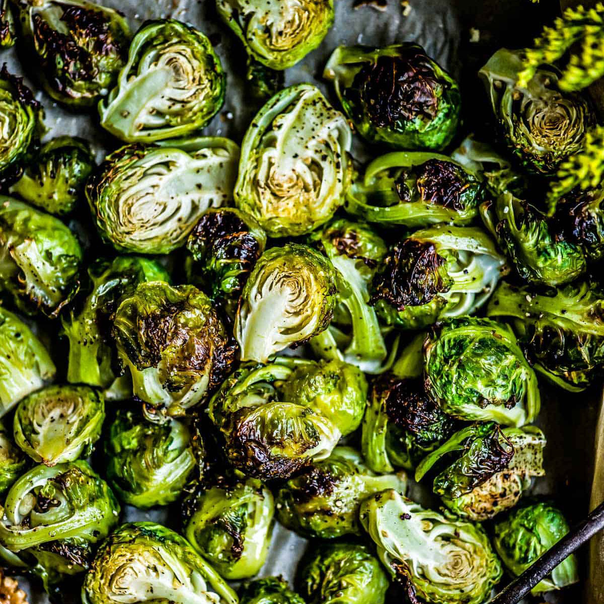 Oven roasted brussels sprouts on a baking sheet.